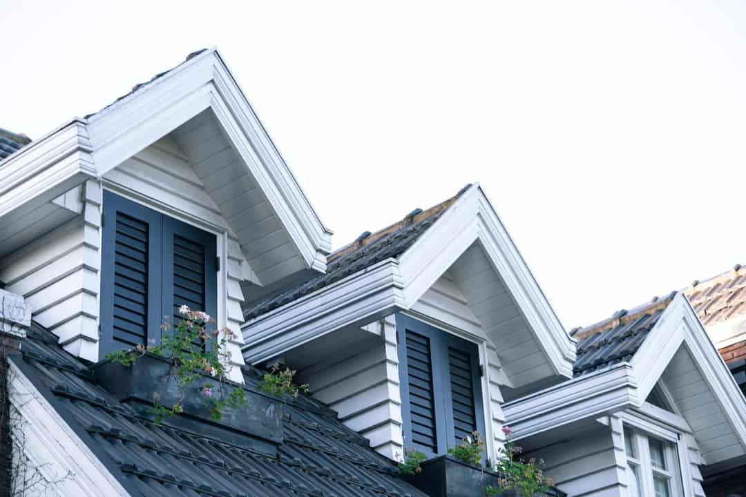 Row of white houses with black shutters