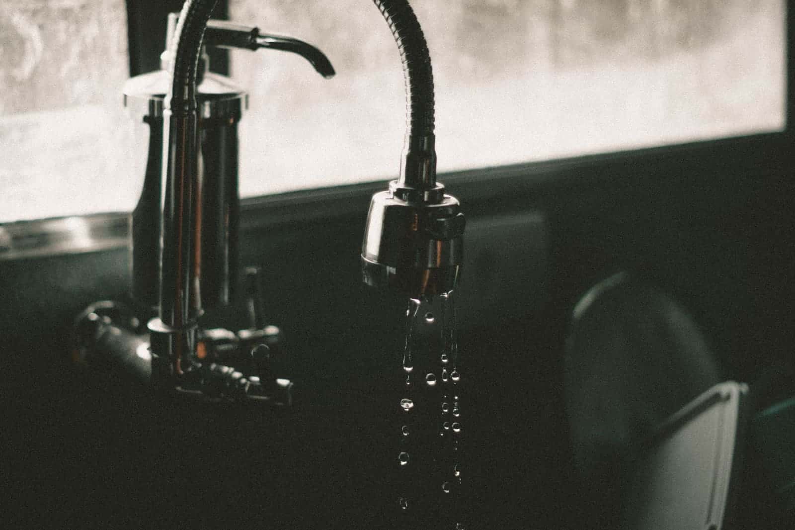 Water droplets falling from a kitchen faucet