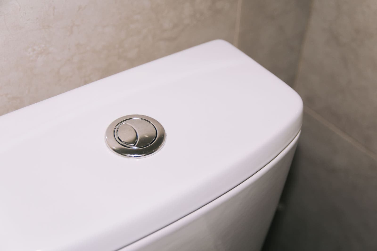 Dual-flush button on a toilet tank