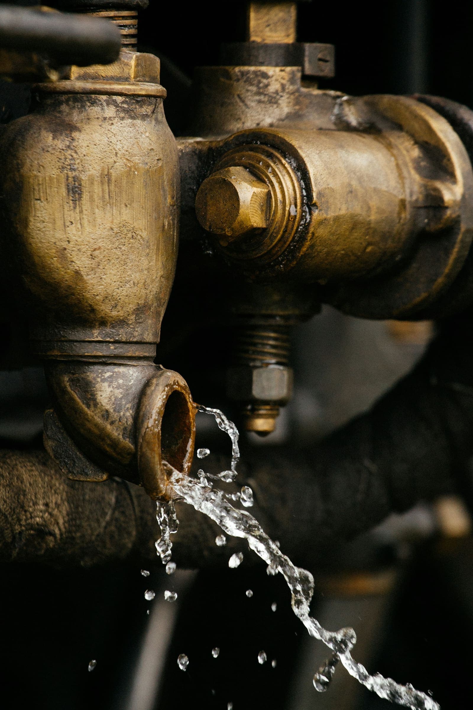 Water dripping from a corroded brass valve