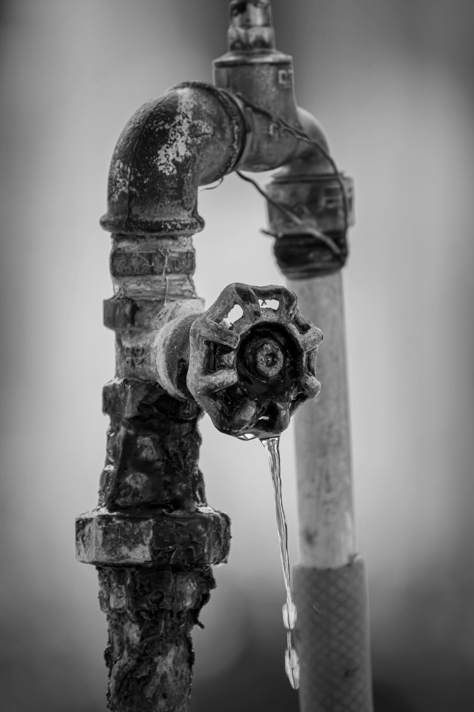 Old corroded faucet dripping water