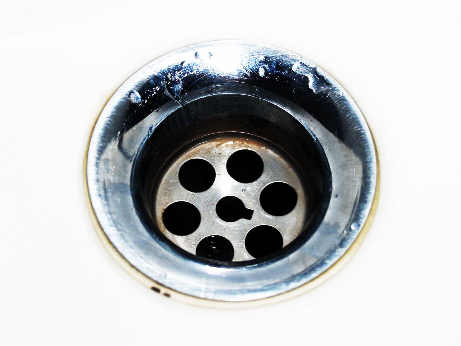 Stainless steel sink drain with water droplets