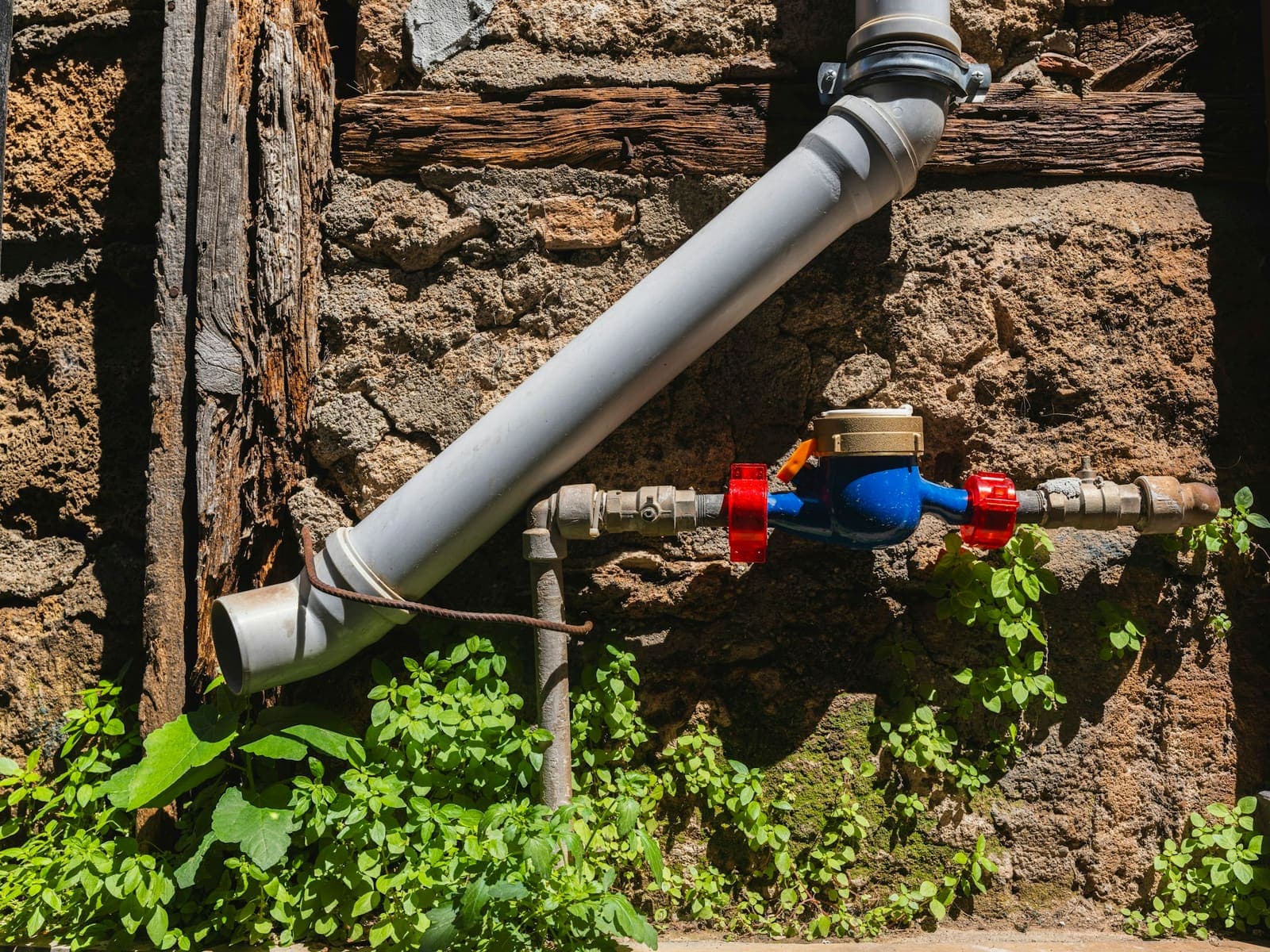 Water meter and supply pipe on an outside wall