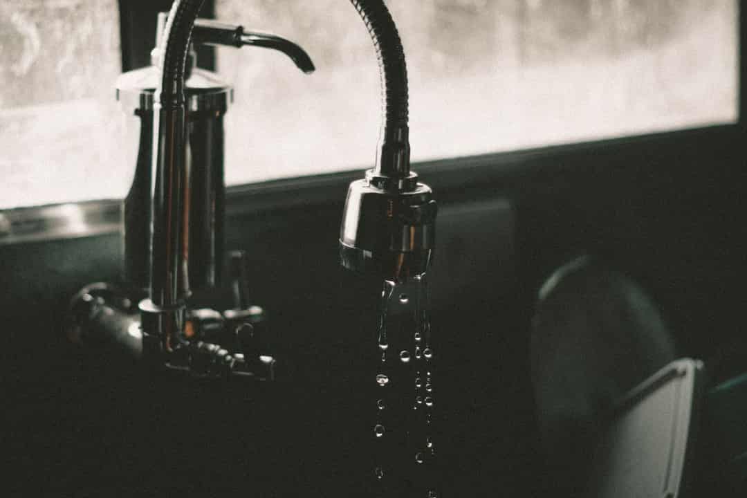 Water droplets falling from a kitchen faucet