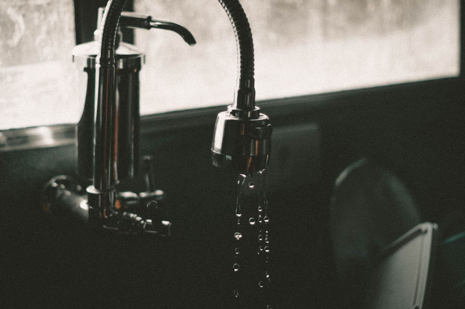 Water droplets falling from a kitchen faucet
