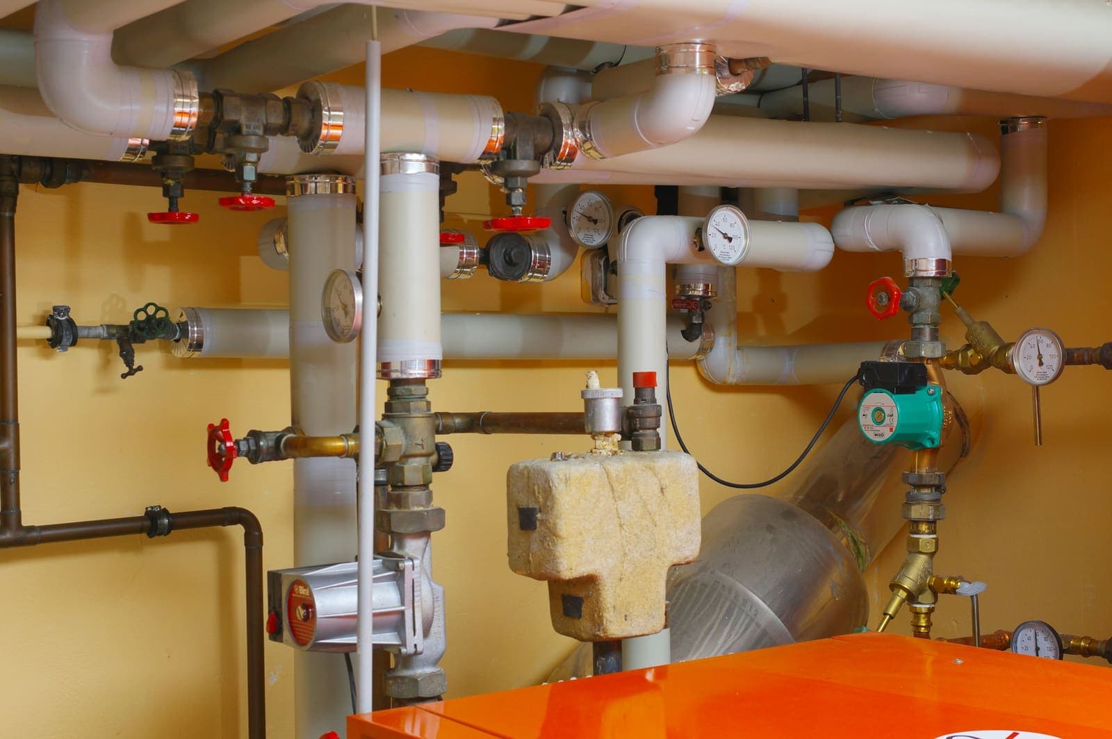 Water pipes and shutoff valves in a utility room