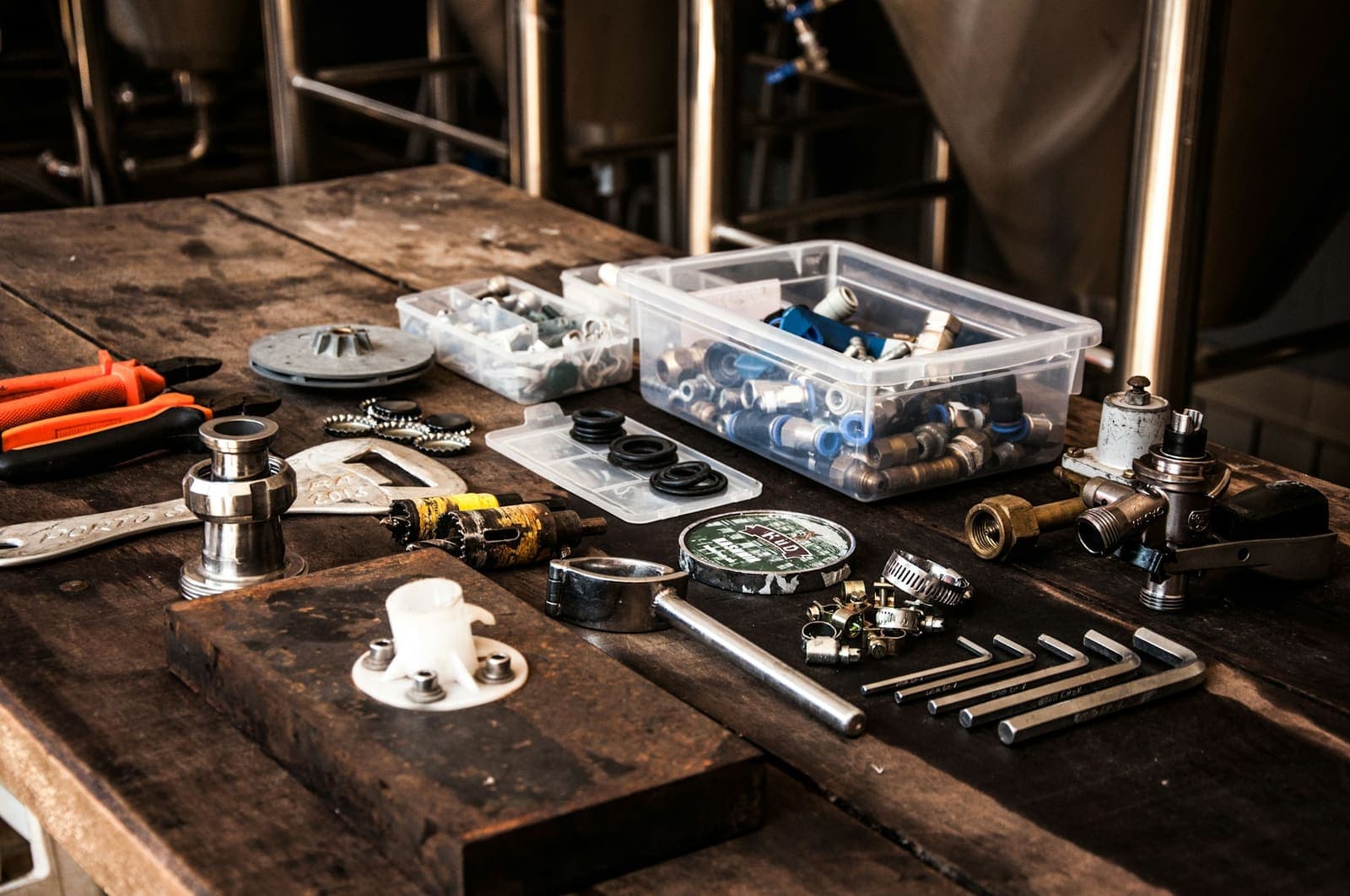 Plumbing fittings, parts and tools laid out on a workbench