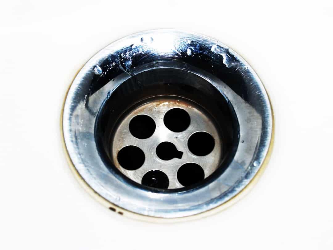 Stainless steel sink drain with water droplets